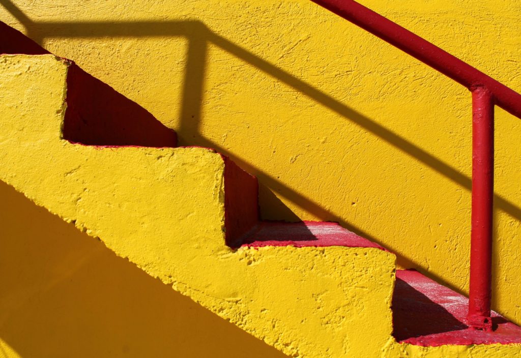 set of bright yellow stairs, climbing to success